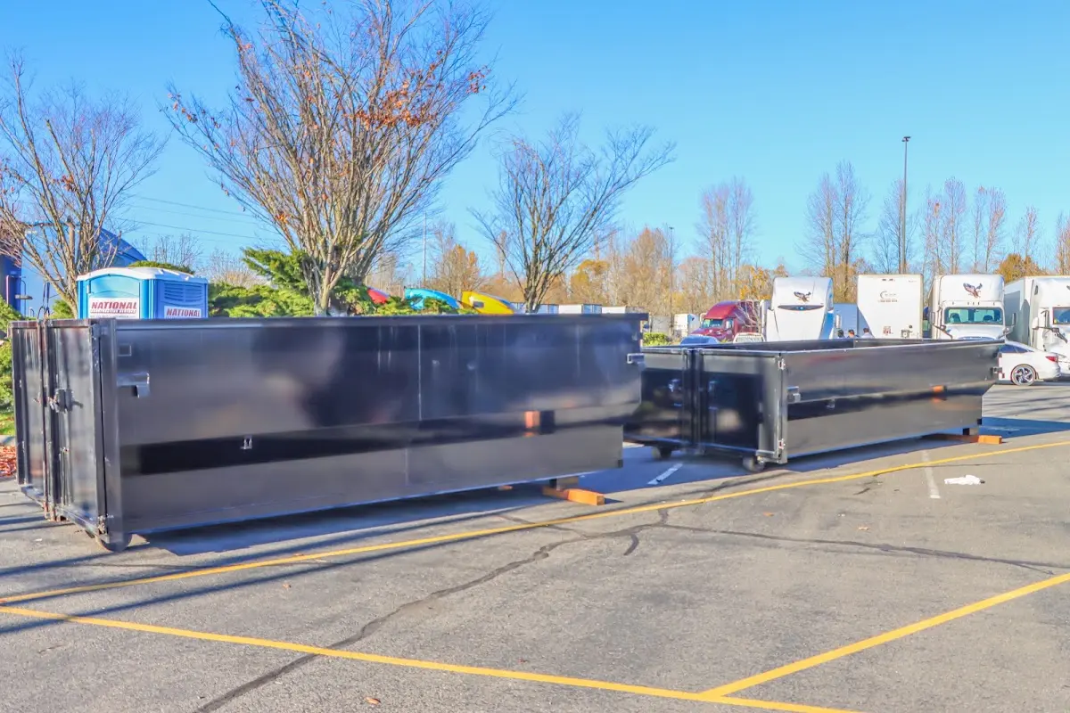 Professional dumpster rental service with roll-off container on residential driveway in Albertville